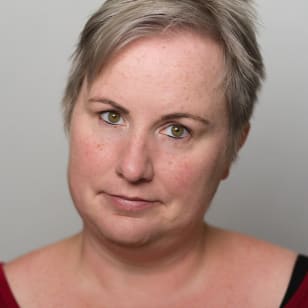 Professional headshot of Kelly, a white woman with short blonde hair.