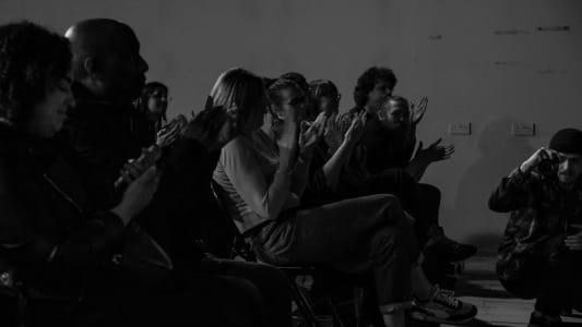 Monochrome image of audiences clapping 