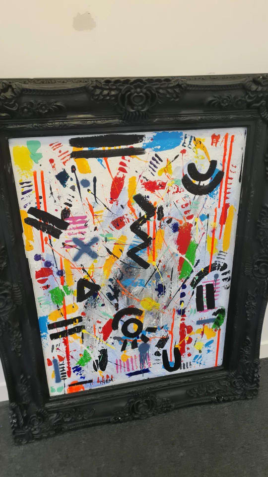 Colourful abstract painting in a black frame